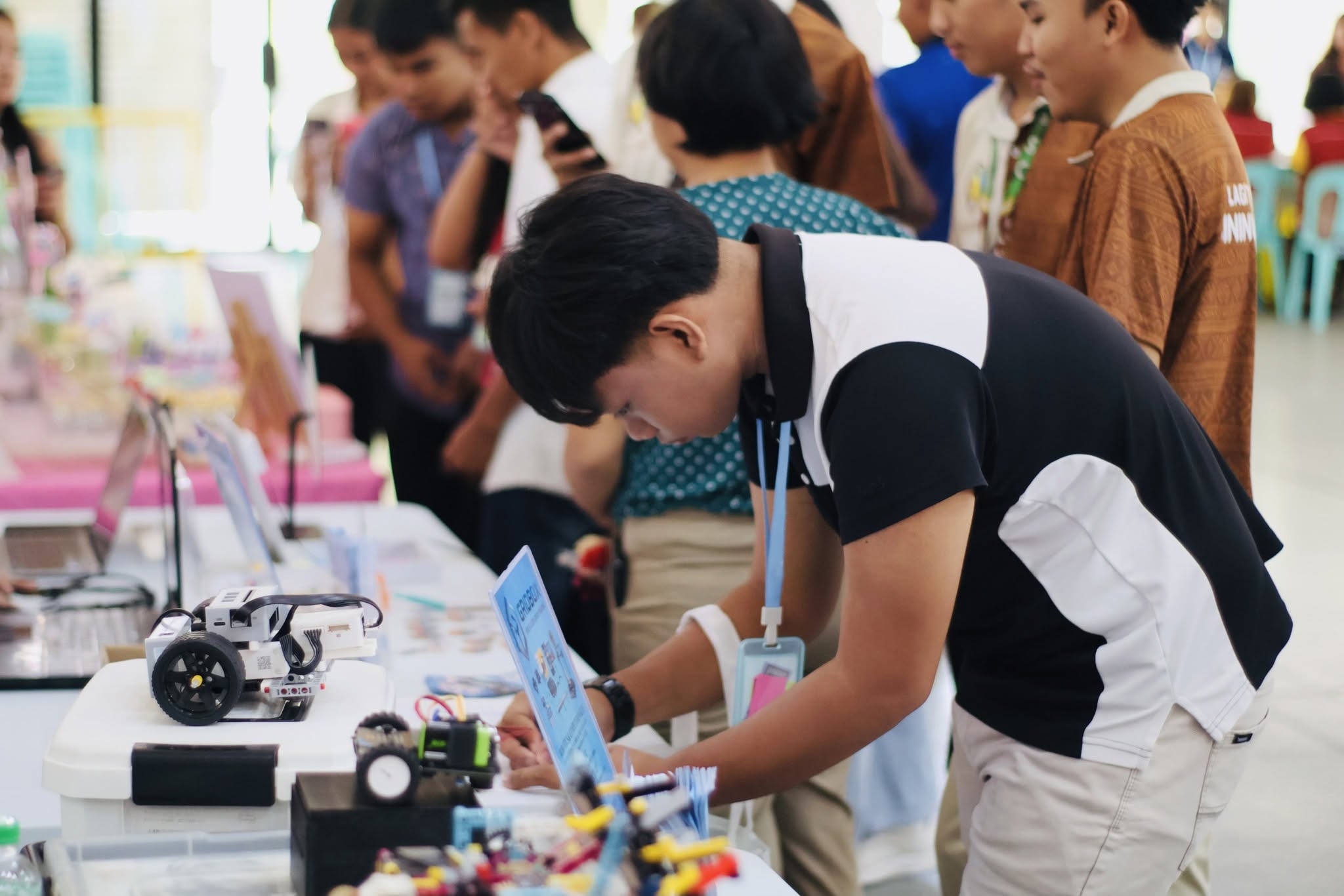 A student at a robotics exhibition table